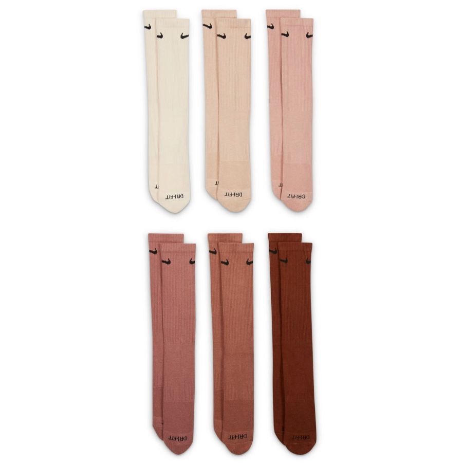 Six pairs of knee-high socks in various shades of beige, pink, and brown, each featuring a small black swoosh logo and \“DRI-FIT\“ text at the toes.