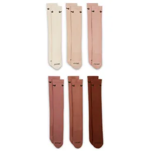 Six pairs of knee-high socks in various shades of beige, pink, and brown, each featuring a small black swoosh logo and \“DRI-FIT\“ text at the toes.