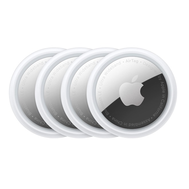 A set of four Apple AirTags, round tracking devices with white and metallic finishes, used for locating personal items via Bluetooth and Ultra Wideband technology.