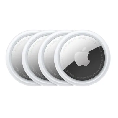 A set of four Apple AirTags, round tracking devices with white and metallic finishes, used for locating personal items via Bluetooth and Ultra Wideband technology.