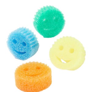Four colorful smiley face cleaning sponges are displayed: one each in green, blue, yellow, and orange.