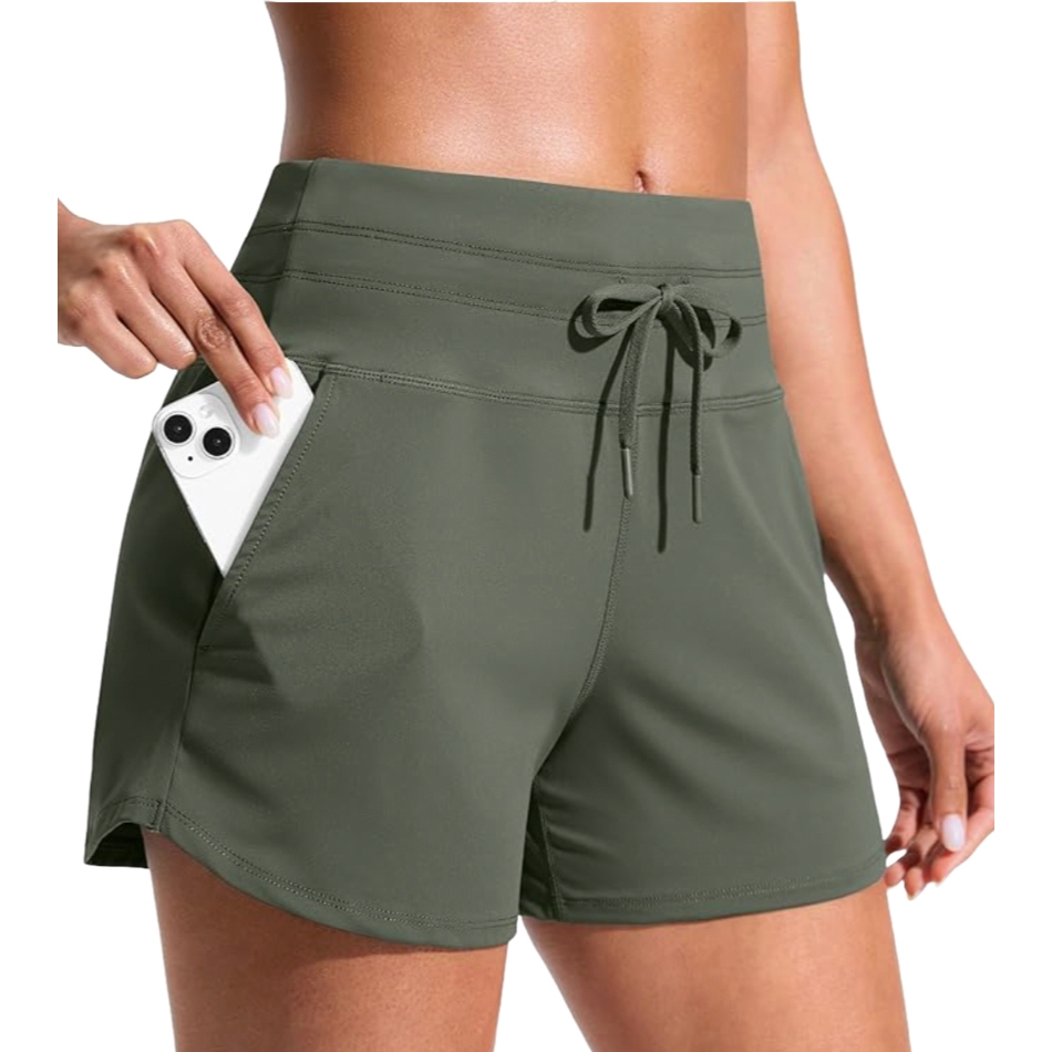 High-waisted olive green athletic shorts with a drawstring and a phone in the side pocket.