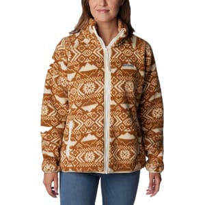 A woman is wearing a brown and white patterned fleece jacket with a zipper front.