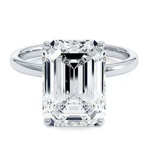 A platinum engagement ring with a large rectangular emerald-cut diamond set in a four-prong setting.