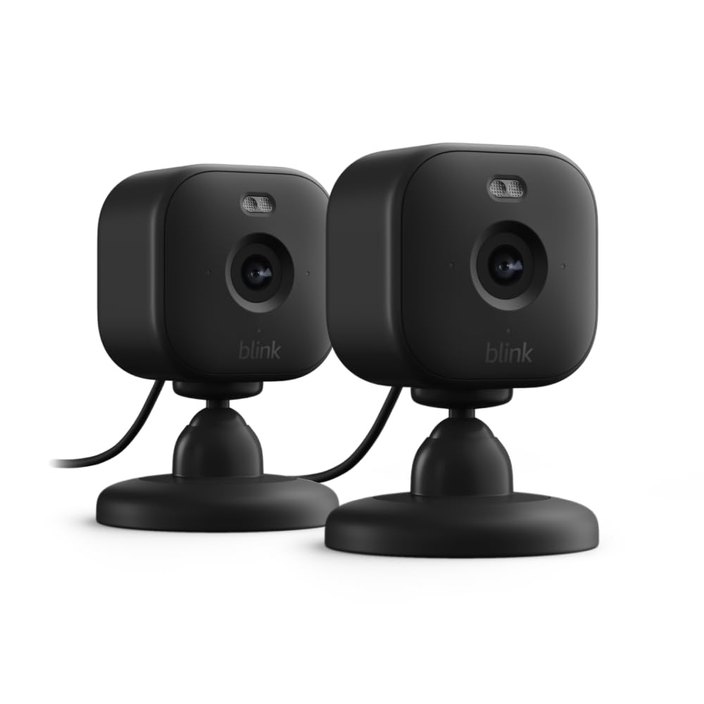 Two black Blink security cameras with stands designed for indoor use, featuring compact square shapes and wired connections.