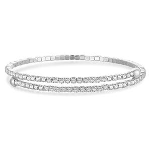 A silver-tone double-row tennis bracelet features two parallel rows of closely set, sparkling gemstones, likely cubic zirconia, on a flexible band.