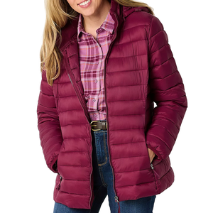 A woman is wearing a maroon puffer jacket over a pink plaid shirt with blue jeans. The jacket has a front zipper and pockets.