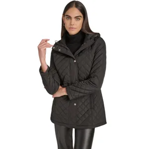 A woman wears a black quilted jacket with a hood and black leather pants. The jacket features a button closure and drawstring waist, paired with a black turtleneck underneath.