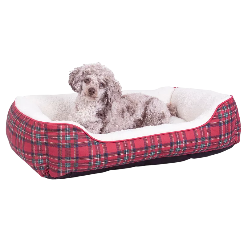 A small dog lies on a rectangular, red plaid dog bed with white fleece lining.