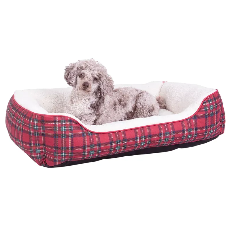 A small dog lies on a rectangular, red plaid dog bed with white fleece lining.