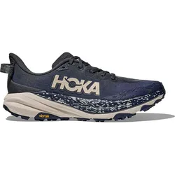 Hoka trail running shoe in dark blue with a beige midsole, featuring a Vibram outsole for enhanced traction.