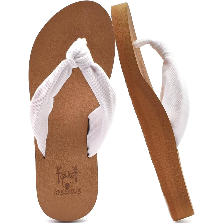 White, thong-style sandals with a brown sole, featuring yoga foam for arch support. The strap is padded for comfort, and the footbed has a textured design with a small deer logo.