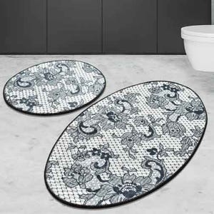 2-piece oval bathroom rug set with a decorative floral and paisley pattern on a mesh-like background, featuring dark outlines and shades of gray.