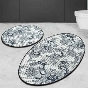 2-piece oval bathroom rug set with a decorative floral and paisley pattern on a mesh-like background, featuring dark outlines and shades of gray.