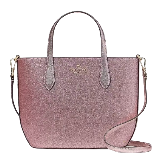 A shimmery pink tote bag with dual handles and a detachable shoulder strap, featuring a Kate Spade New York logo.