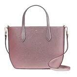 A shimmery pink tote bag with dual handles and a detachable shoulder strap, featuring a Kate Spade New York logo.
