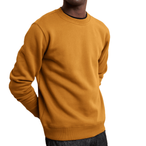 A man wears a mustard-colored Banana Republic Factory men's fleece sweatshirt with a crew neck and long sleeves, paired with dark pants.