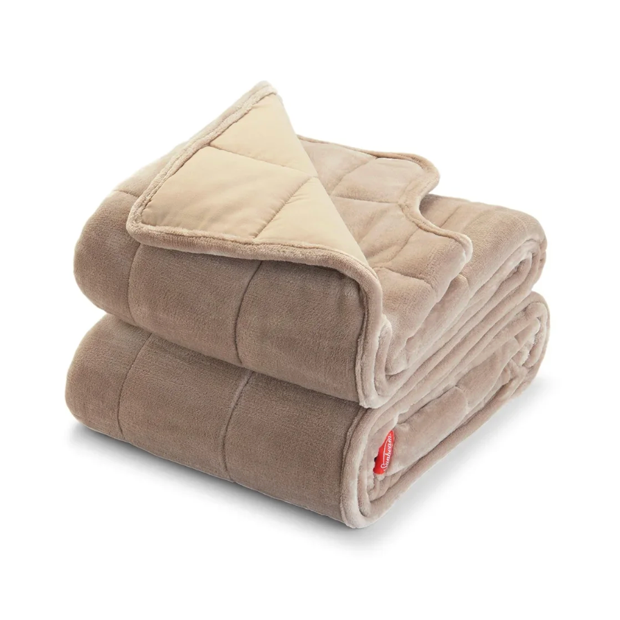A soft, tan fleece blanket with a quilted design, featuring a contrasting lighter inner lining and a red tag.