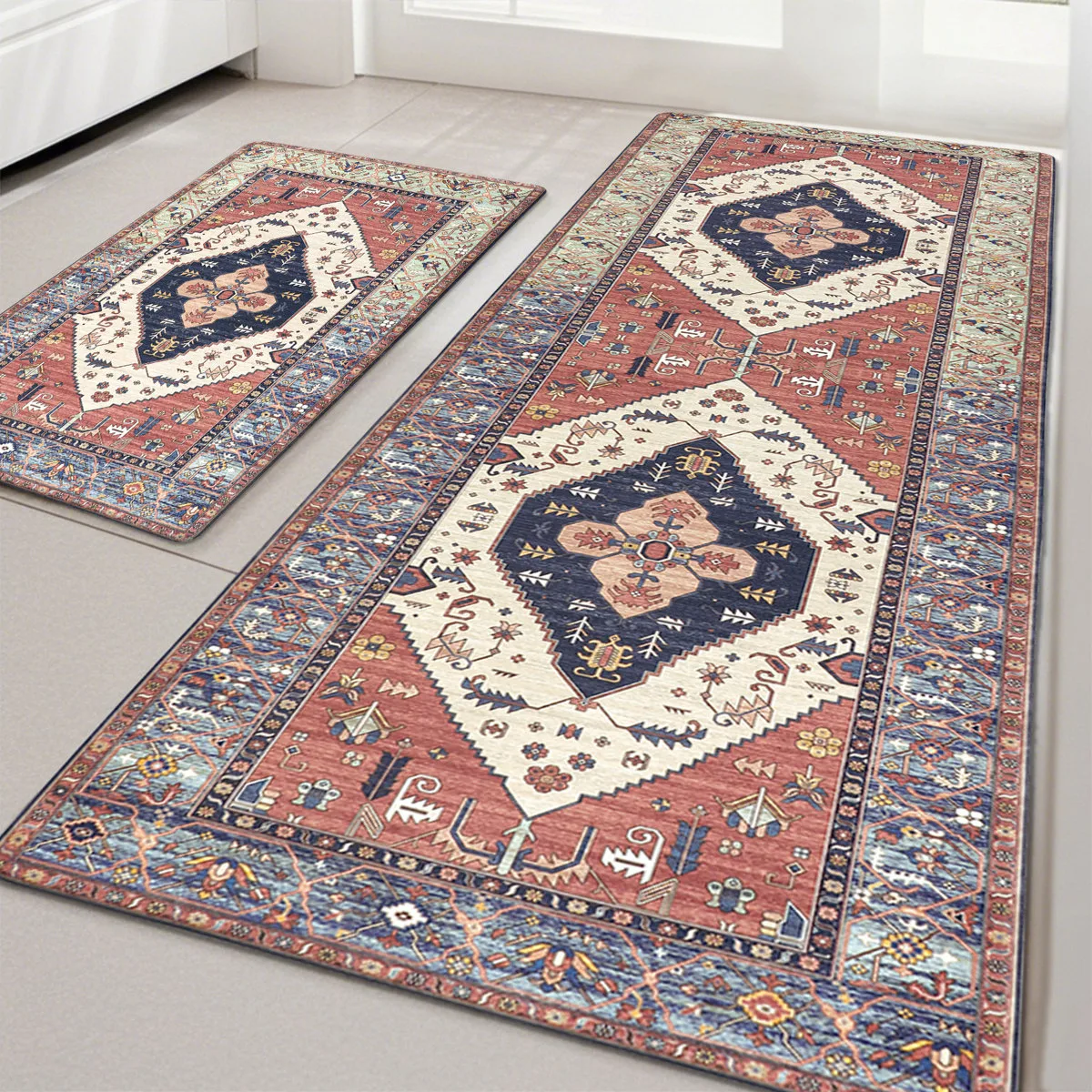 Two rectangular area rugs with intricate geometric and floral patterns in blue, red, and cream tones are placed on a light-colored floor.