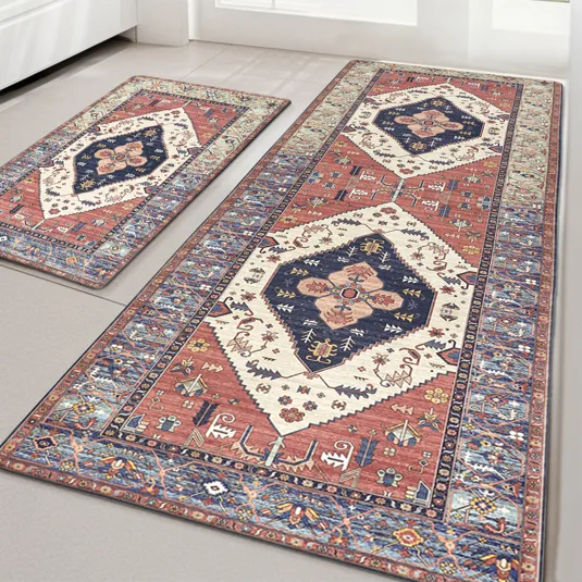 Two rectangular area rugs with intricate geometric and floral patterns in blue, red, and cream tones are placed on a light-colored floor.