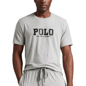 A person is wearing a light gray short-sleeved T-shirt with \“POLO RALPH LAUREN\“ printed on the front, paired with matching gray drawstring pants.