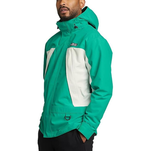 A man is wearing a green and white hooded jacket with a front zipper and pockets.