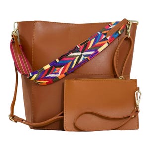 A brown leather shoulder bag with a colorful woven strap, accompanied by a matching leather wallet.