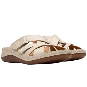Beige open-toe sandals with wide straps and a Velcro closure, featuring a brown sole designed for comfort and casual wear.