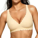 A beige bra with scalloped edges and wide straps, offering a seamless design and light support.