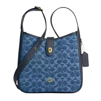 Blue Coach shoulder bag featuring the signature \“C\“ pattern, leather trim, gold-tone hardware, and a Coach tag.