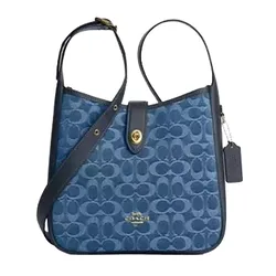 Blue Coach shoulder bag featuring the signature \“C\“ pattern, leather trim, gold-tone hardware, and a Coach tag.