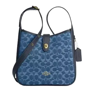Blue Coach shoulder bag featuring the signature \“C\“ pattern, leather trim, gold-tone hardware, and a Coach tag.