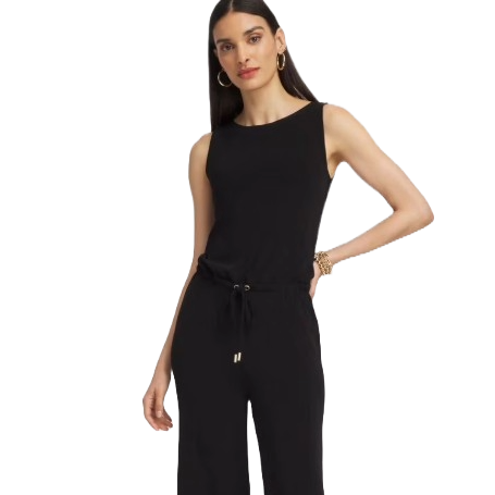 A sleeveless black jumpsuit with a drawstring waist, worn by a woman with long hair, accessorized with hoop earrings and bracelets.