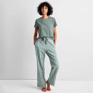 Plaid pajama pants with a drawstring waist, featuring a green and white checkered pattern.