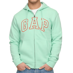 A mint green full-zip hoodie with a front kangaroo pocket, featuring \“GAP\“ in large letters on the chest. The hoodie has a drawstring hood and is paired with blue jeans.