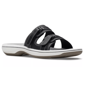 Black sandal with white stitching, two adjustable straps, and a cushioned rubber sole with a white and gray color scheme.