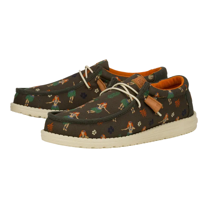 A pair of casual shoes with a dark background and a playful print featuring small birds and botanical elements, accented with orange lining and leather details.