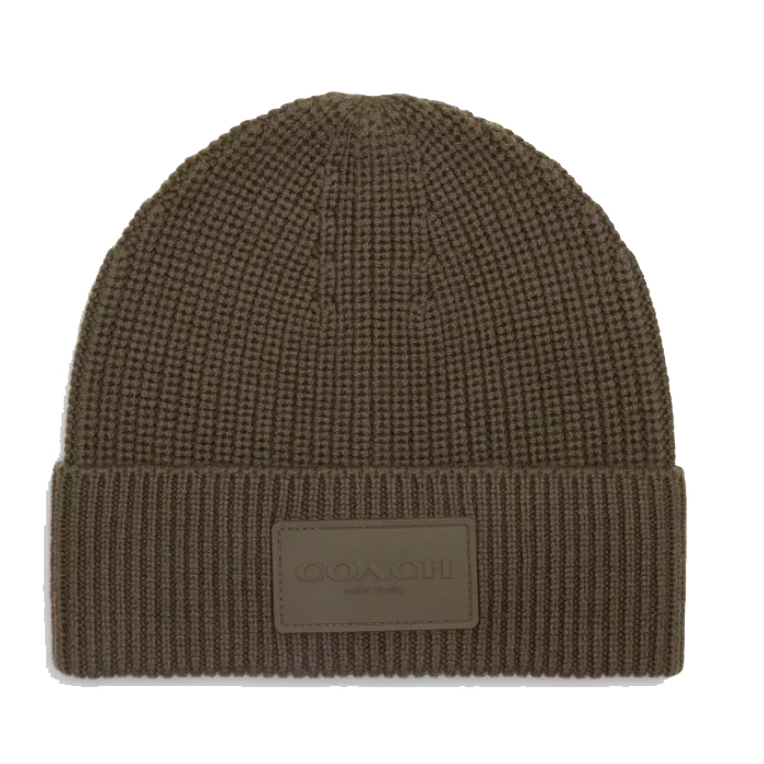 A brown Coach knit beanie featuring a ribbed design with a fold-over cuff and a prominent rubber patch displaying the Coach logo.