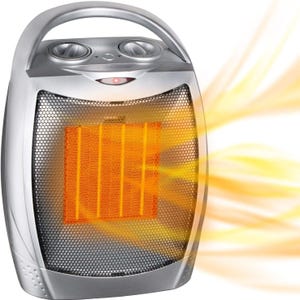 Portable electric space heater with a metallic finish, featuring adjustable knobs on top for temperature control and a front grill emitting warm, glowing heat.