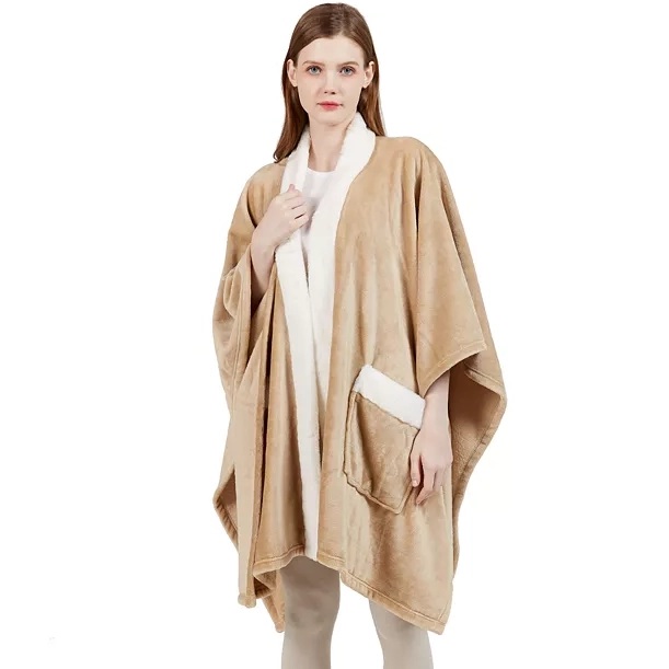 A woman wearing a beige poncho with white interior lining.