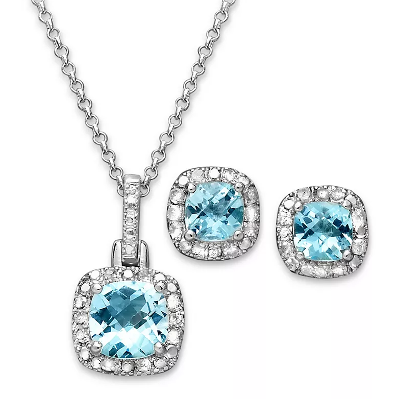 A jewelry set featuring a pendant necklace and stud earrings, each showcasing a cushion-cut blue gemstone surrounded by a halo of diamond accents, all set in a polished silver tone.