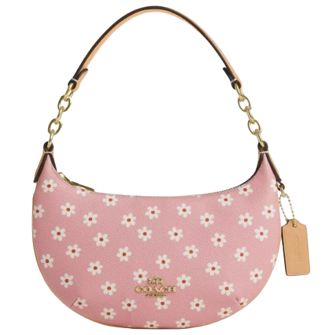 A pink Coach handbag with white daisy patterns, featuring a gold-tone chain strap and a leather tag.