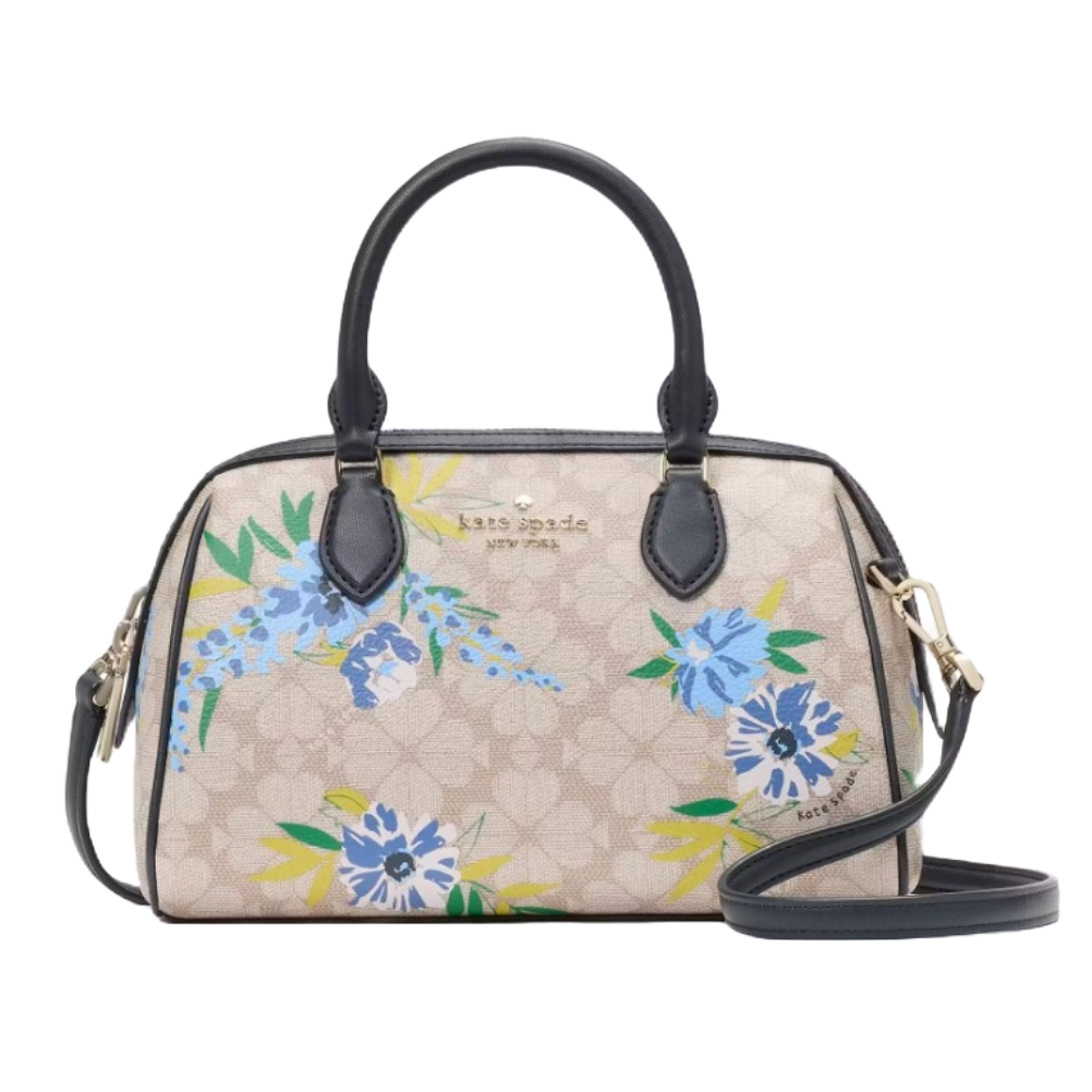 Kate Spade large floral duffle bag features a beige background with blue and green floral patterns, black handles, and a detachable shoulder strap. The bag has gold-tone hardware and \“kate spade NEW YORK\“ branding.