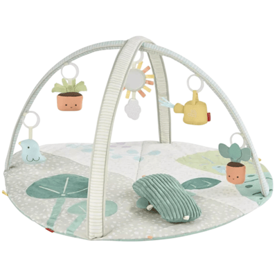 A baby play gym featuring a soft, padded mat with a botanical theme, arches with hanging toys including a bird, sun, cloud, and potted plants, designed for infants to engage and play.
