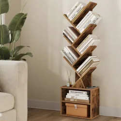 A wooden bookshelf with a unique zigzag design holds various books, alongside a square base featuring additional books and a storage box. A small diffuser is placed on top, next to a potted plant.