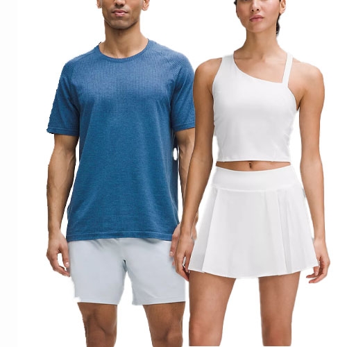 Male model wearing a blue short-sleeve shirt and white shorts; female model wearing a white one-shoulder crop top and pleated skirt.