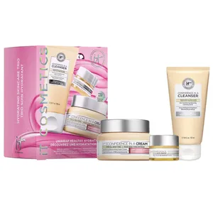 A set of IT Cosmetics \“Confidence\“ skincare products, including a cleanser, moisturizing cream, and eye cream, packaged in a pink box with branding and product images.