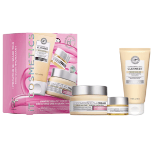 A set of IT Cosmetics \“Confidence\“ skincare products, including a cleanser, moisturizing cream, and eye cream, packaged in a pink box with branding and product images.