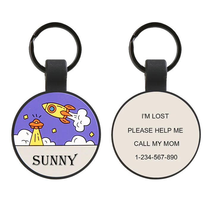 A round keychain with a colorful rocket design and the word \“SUNNY\“ on one side; the other side states, \“I'M LOST, PLEASE HELP ME, CALL MY MOM\“ with a contact number.