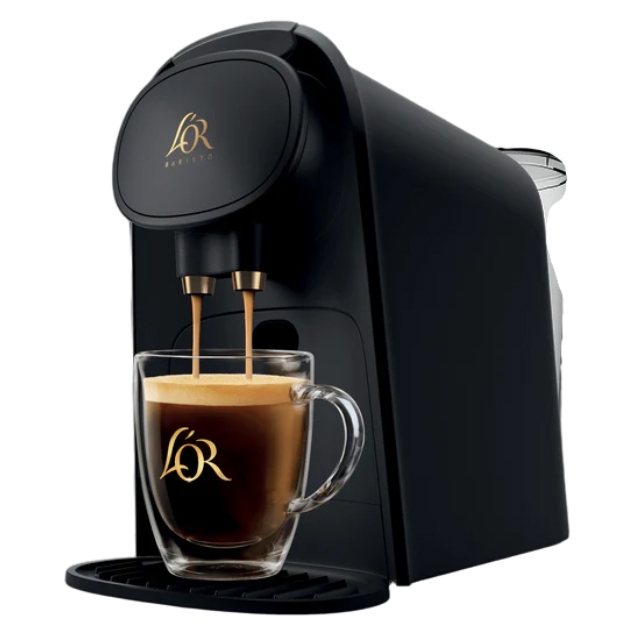 L'Or Barista Coffee & Espresso Maker is a sleek black machine with dual spouts, brewing coffee into a clear glass mug. It's designed for making both coffee and espresso, featuring the L'Or logo prominently on the machine and mug.